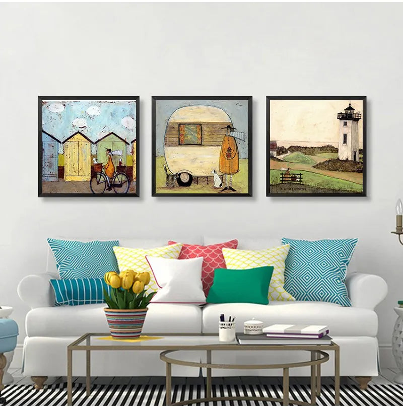Living room with a white sofa, colorful pillows, and three framed artworks on the wall.