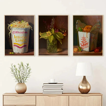 Three framed artworks on a wall above a wooden console table with decorative items.