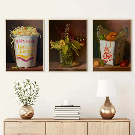 Three framed artworks on a wall above a wooden console table with decorative items. Canvas & Curio