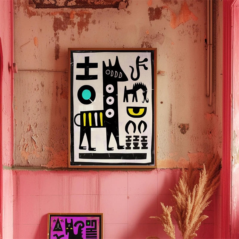 Framed abstract artwork on a textured pink wall with a plant in the foreground.