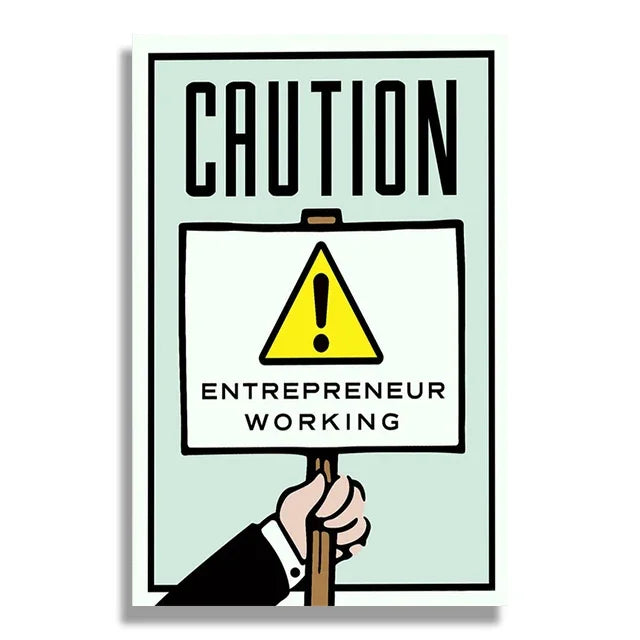 Cartoon hand holding a sign with 'Caution: Entrepreneur Working' text on a light green background