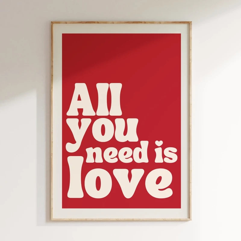 Framed poster with 'All you need is love' text on a red background