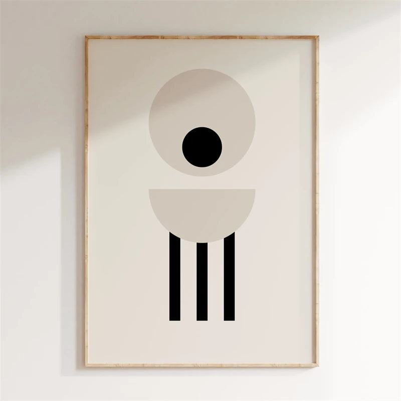 Framed abstract art print with geometric shapes on a plain wall