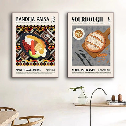 Two framed posters on a wall above a dining table with chairs. Canvas & Curio