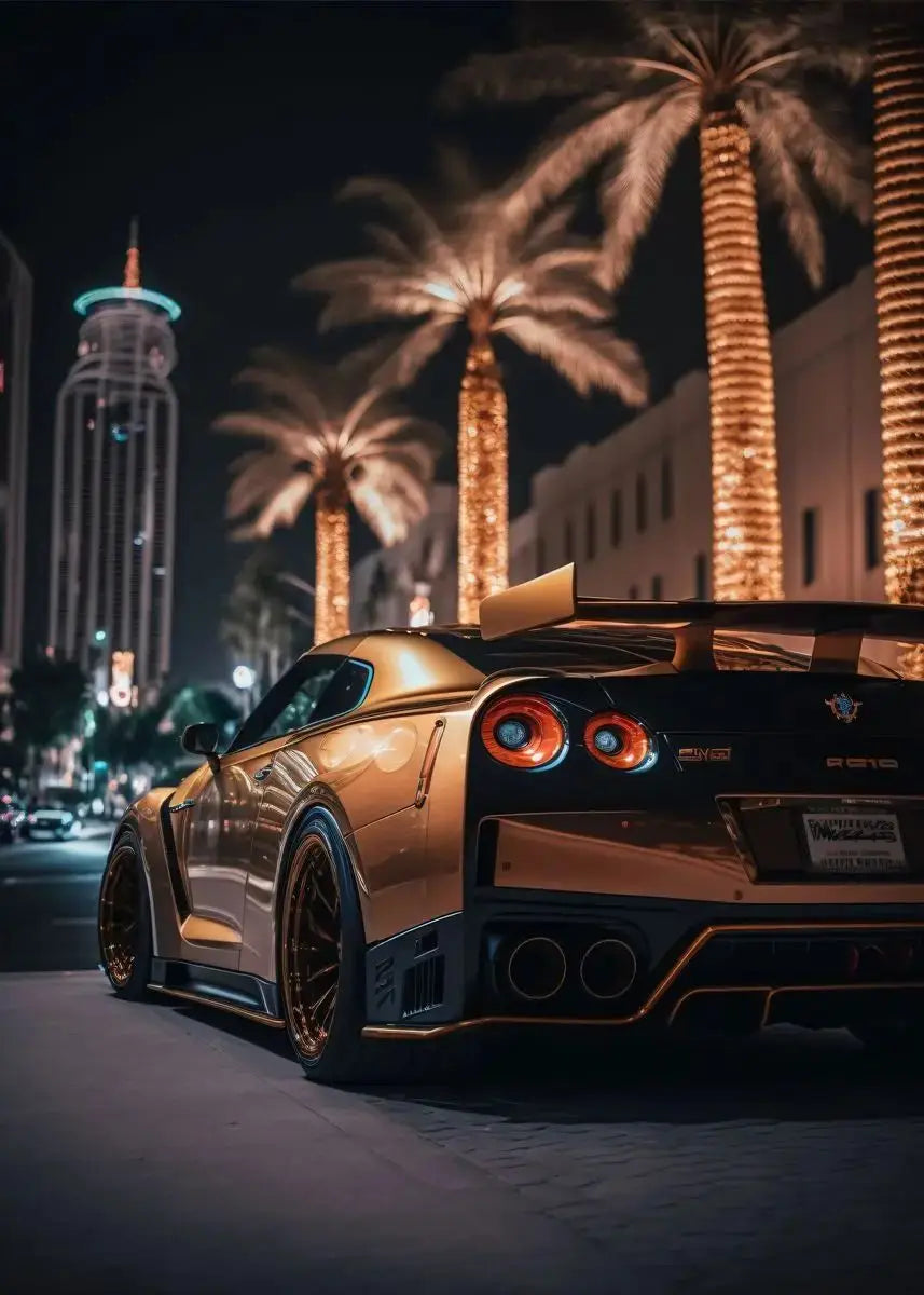 Luxury car on a city street at night with palm trees and a tall building in the background.