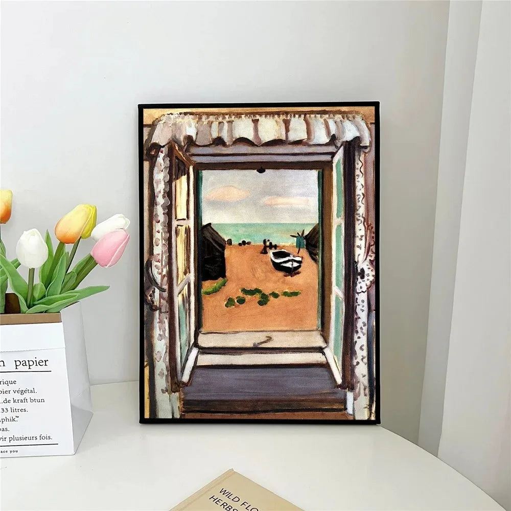 Framed artwork of a beach scene with a door opening to a sandy path.