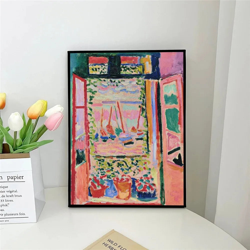 Framed colorful painting of a window scene on a white surface with tulips.