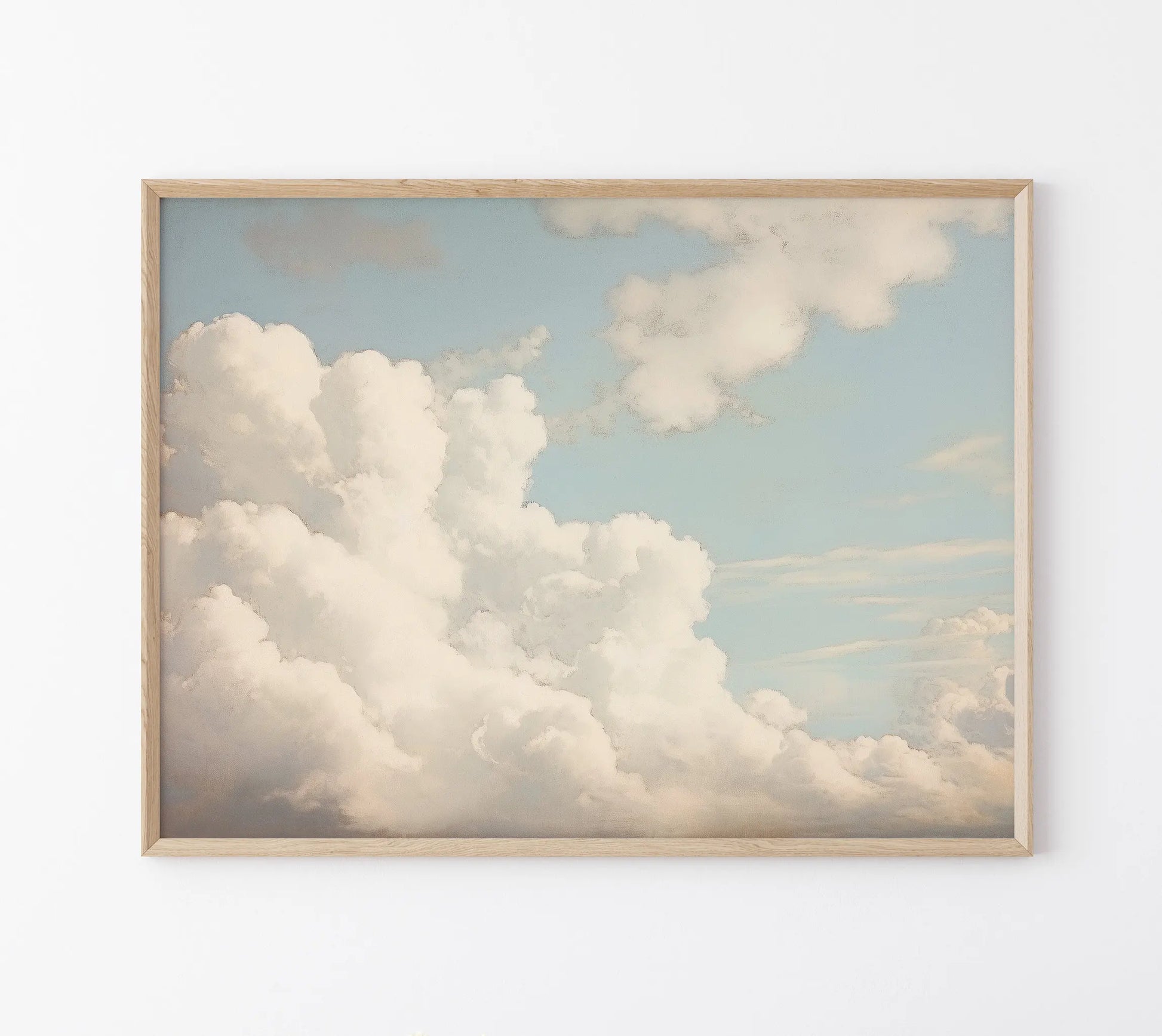 Framed artwork of a cloud scene on a white wall