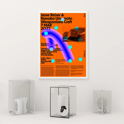 Poster with event details on an orange background, displayed on a white wall with decorative items below.