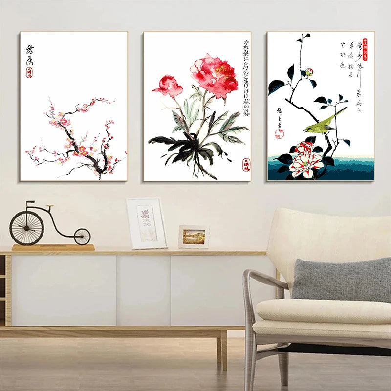 Three floral artworks on a wall above a sofa in a living room.