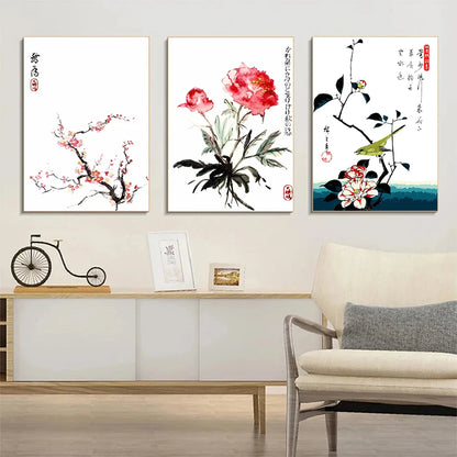 Three floral artworks on a wall above a sofa in a living room.