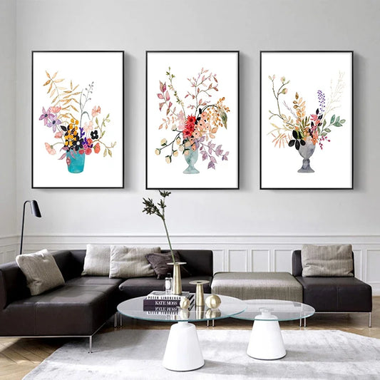 Three framed floral prints on a wall above a modern living room setup. Canvas & Curio