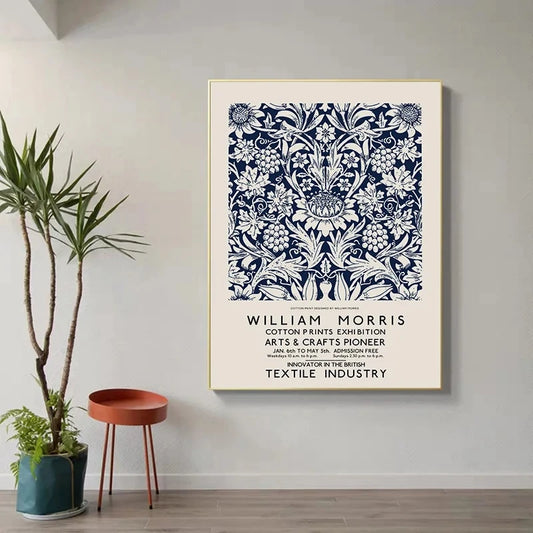 Framed artwork of William Morris design on a wall with a plant and small table in the foreground. Canvas & Curio
