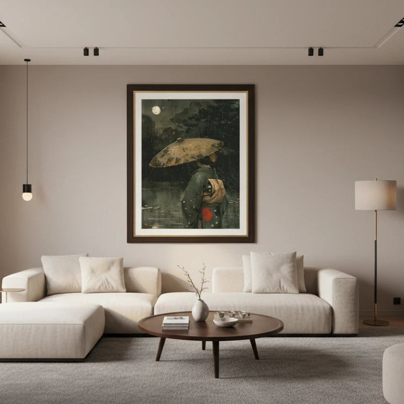 Modern living room with a white sofa, round coffee table, and framed artwork on the wall.