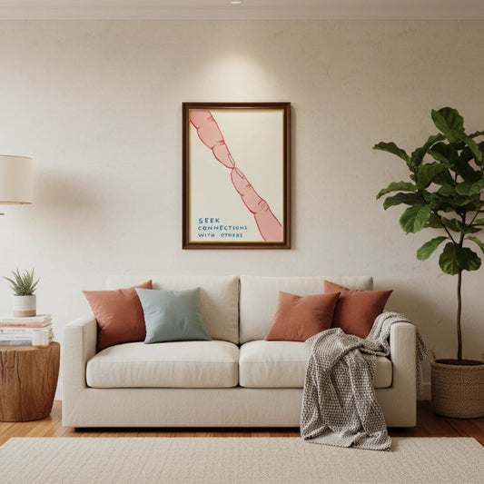 Living room with a white couch, decorative pillows, and a framed artwork on the wall. Canvas & Curio