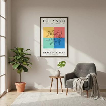 Living room with a gray armchair, plant, and Picasso poster on the wall.